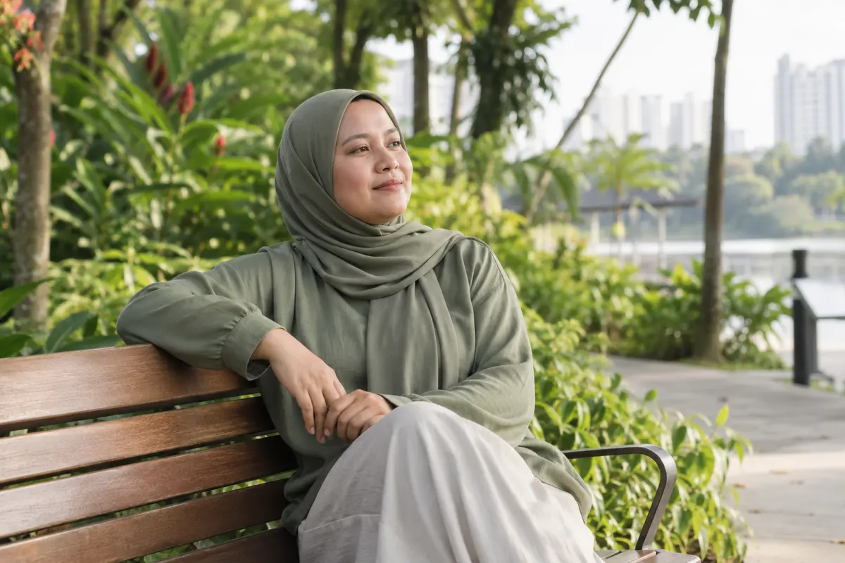 Taking a calm moment on a park bench surrounded by greenery